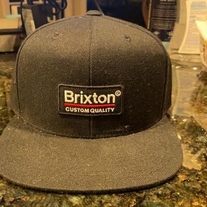 The Brixton Custom Quality Logo snap back cap.